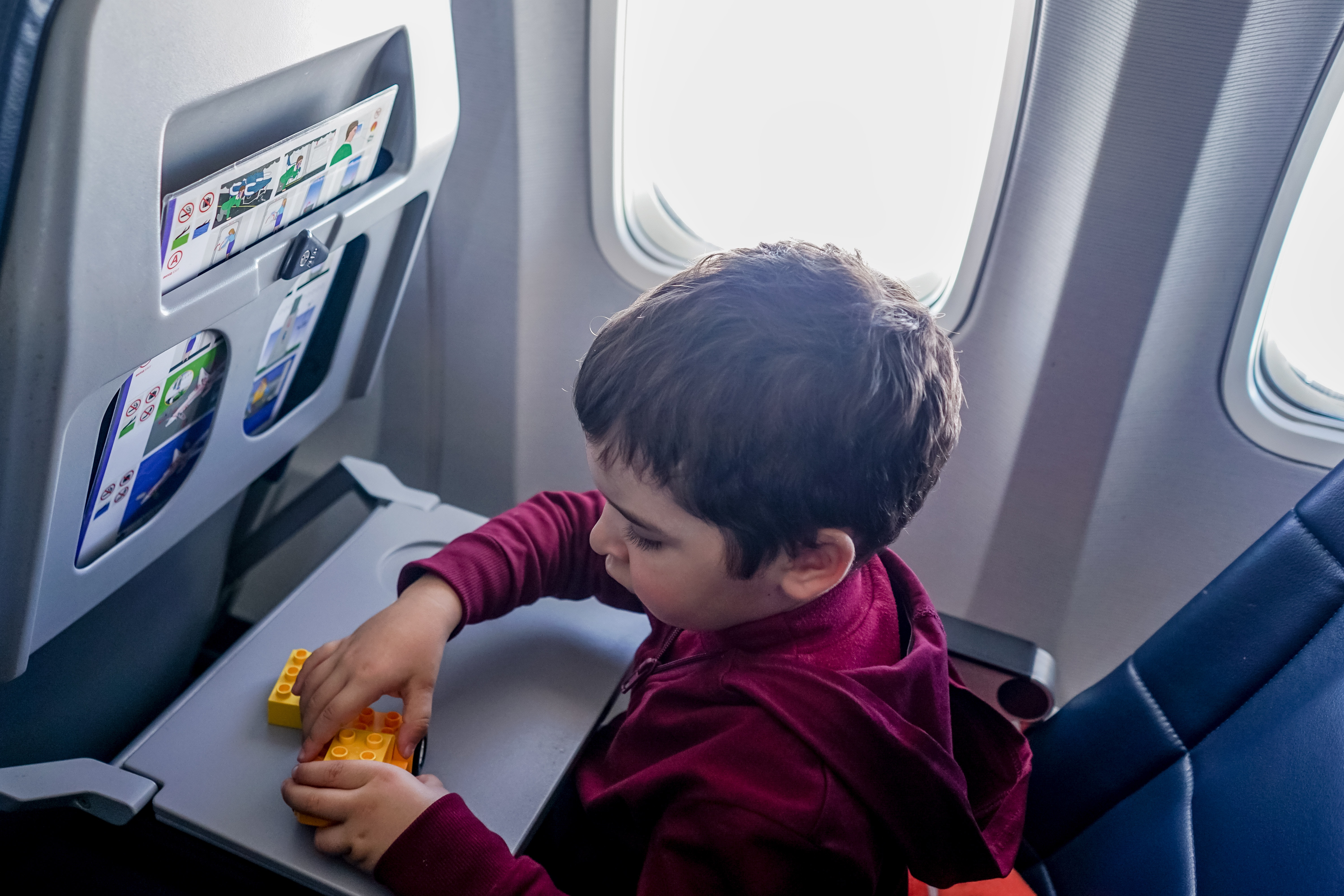photo by oleksandr pidvalnyi: https://www.pexels.com/photo/boy-playing-with-toy-on-plane-5771207/
