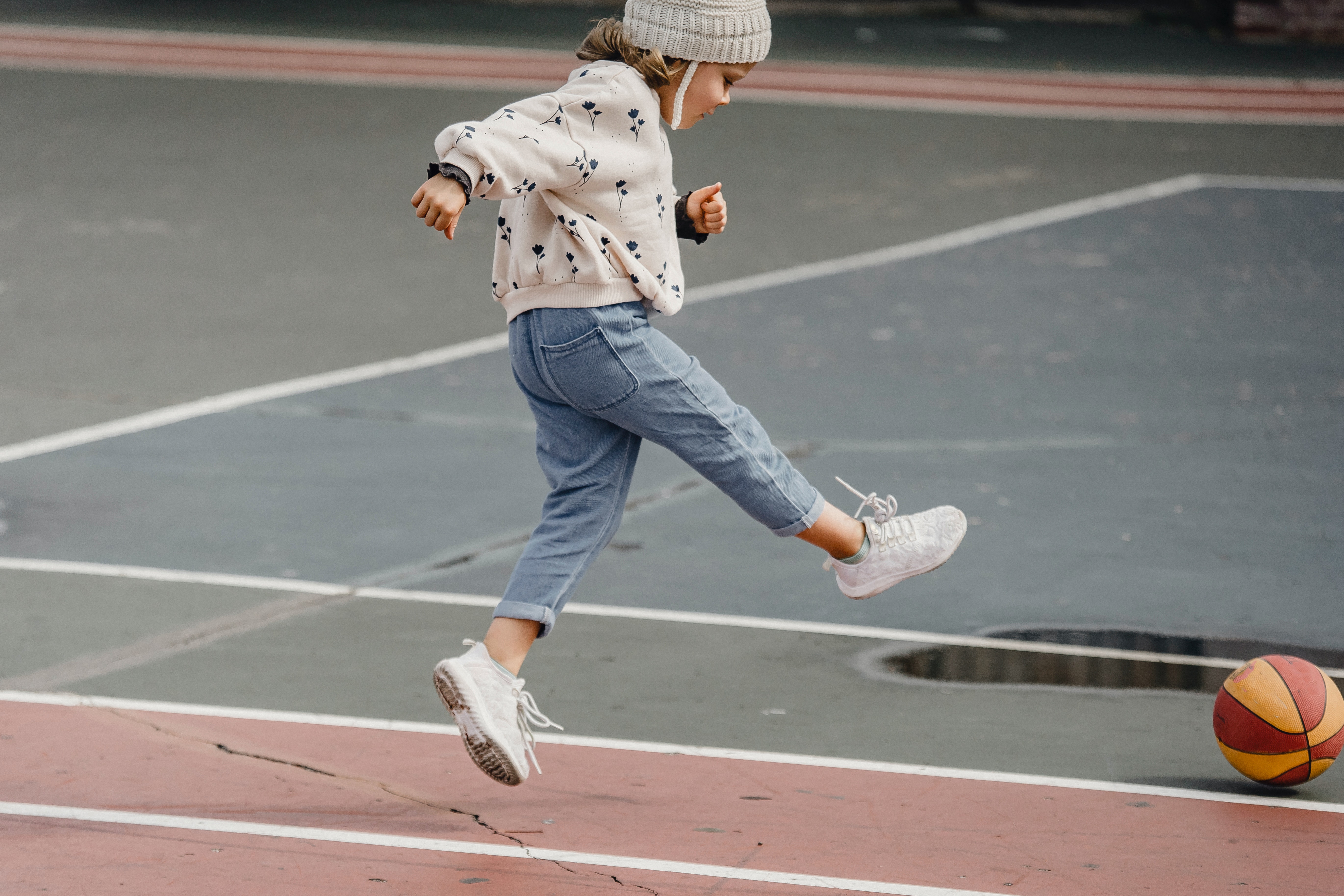 photo by allan mas: https://www.pexels.com/photo/little-girl-jumping-while-playing-with-ball-on-sports-ground-5623062/